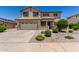 Two-story home with a two-car garage, tiled roof, desert landscaping, and covered entry at 16450 W Lilac St, Goodyear, AZ 85338