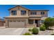 A two-story home with a two-car garage, tiled roof, desert landscaping, and covered entry at 16450 W Lilac St, Goodyear, AZ 85338