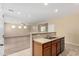 Open kitchen features stainless steel appliances and breakfast bar at 16450 W Lilac St, Goodyear, AZ 85338