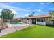 Expansive backyard featuring manicured lawn and a fenced pool, offering privacy and outdoor enjoyment at 1713 W Royal Palm Rd, Phoenix, AZ 85021