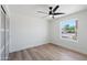 Bright, minimalist bedroom with natural light, a ceiling fan and modern sliding closet doors at 1713 W Royal Palm Rd, Phoenix, AZ 85021