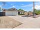 Street view of a ranch-style home featuring a two-car garage and desert landscaping at 1713 W Royal Palm Rd, Phoenix, AZ 85021
