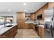 Updated kitchen with stainless steel appliances, modern cabinetry, and a spacious island at 1713 W Royal Palm Rd, Phoenix, AZ 85021