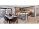 Modern kitchen with stainless steel appliances, an island, and sleek countertops adjacent to dining area at 1713 W Royal Palm Rd, Phoenix, AZ 85021