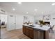 Bright kitchen with modern island and stainless steel appliances, connected to dining area at 1713 W Royal Palm Rd, Phoenix, AZ 85021