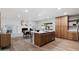 Open-concept living space with a fireplace, dining area, and updated kitchen, perfect for entertaining at 1713 W Royal Palm Rd, Phoenix, AZ 85021