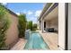 Backyard featuring a sleek pool, patio area, and lush landscaping at 17146 W Mountainair St, Surprise, AZ 85388