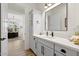 Bright bathroom featuring quartz countertop, modern fixtures, and a view of the adjacent office at 17146 W Mountainair St, Surprise, AZ 85388