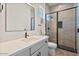 Modern bathroom featuring tiled walls, a glass-enclosed shower, and a sleek vanity at 17146 W Mountainair St, Surprise, AZ 85388