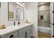 Stylish bathroom with quartz countertop, modern fixtures, and tiled shower at 17146 W Mountainair St, Surprise, AZ 85388