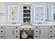 Bright bathroom featuring double vanity, quartz countertop, modern fixtures, and built-in storage at 17146 W Mountainair St, Surprise, AZ 85388
