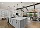 Kitchen island with white countertop, stainless steel sink, and views of the dining and living area at 17146 W Mountainair St, Surprise, AZ 85388