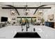 Bright, open-concept kitchen with large island, modern lighting, and seamless transition to the living and dining area at 17146 W Mountainair St, Surprise, AZ 85388