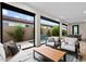 Inviting living room with comfortable seating, seamless transition to the beautiful backyard with a water feature at 17146 W Mountainair St, Surprise, AZ 85388