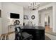 Home office featuring a grand desk, stylish chandelier, and neutral decor at 17146 W Mountainair St, Surprise, AZ 85388