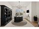 Home office featuring a grand desk, bookshelves, and shuttered windows at 17146 W Mountainair St, Surprise, AZ 85388