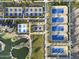 Overhead shot of well-maintained pickleball and tennis courts with lush landscaping and a picturesque pond nearby at 17146 W Mountainair St, Surprise, AZ 85388