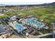 Fantastic aerial view showcases the community pool, surrounding buildings, and lush landscaping of this property at 17146 W Mountainair St, Surprise, AZ 85388