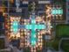 Aerial view of the community pool illuminated at night, surrounded by lounge areas and lush landscaping at 17146 W Mountainair St, Surprise, AZ 85388