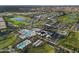 Overhead view of a community pool and clubhouse area, surrounded by lush green golf course at 17146 W Mountainair St, Surprise, AZ 85388