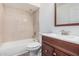 Bathroom showcasing a vanity with wood cabinet, with a shower-tub combo featuring tile surround at 17201 N 35Th Dr, Glendale, AZ 85308