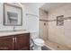 Updated bathroom featuring tiled shower, granite countertop, and dark wood vanity cabinet at 17201 N 35Th Dr, Glendale, AZ 85308