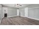 Spacious bedroom with wood-look floors, gray walls, white trim and two closets, one leading to an ensuite bathroom at 17201 N 35Th Dr, Glendale, AZ 85308