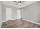 Clean bedroom with laminate floors, baseboards and an open doorway to another room at 17201 N 35Th Dr, Glendale, AZ 85308
