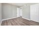Bedroom featuring laminate floors, white baseboards, and two large closets for ample storage at 17201 N 35Th Dr, Glendale, AZ 85308