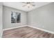 Neutral bedroom with laminate floors, baseboards and a large window bringing in natural light at 17201 N 35Th Dr, Glendale, AZ 85308
