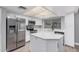 Bright kitchen with stainless steel appliances, white cabinets, and a large island with a white countertop at 17201 N 35Th Dr, Glendale, AZ 85308
