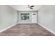 Bright living room with new flooring, fresh paint, a ceiling fan, and a large window, creating a welcoming atmosphere at 17201 N 35Th Dr, Glendale, AZ 85308