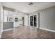 Bright living room with tile floors opening up to a modern kitchen featuring stainless steel appliances and ample storage at 17201 N 35Th Dr, Glendale, AZ 85308