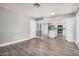 Bright living room with tile floors opening up to a modern kitchen featuring stainless steel appliances and ample storage at 17201 N 35Th Dr, Glendale, AZ 85308