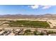 An aerial view of a neighborhood showing nearby desert landscape and distant mountains at 18432 W Port Royale Ln, Surprise, AZ 85388