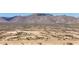This aerial shot shows a community in a desert area with nearby mountains at 18432 W Port Royale Ln, Surprise, AZ 85388