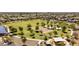 Aerial view of a community park featuring a playground, sand volleyball, and lush landscaping at 18432 W Port Royale Ln, Surprise, AZ 85388