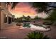 View of the backyard featuring an in-ground pool, patio, lounge furniture, and desert landscaping at 18432 W Port Royale Ln, Surprise, AZ 85388