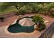 Overhead view of a backyard pool with water feature and meticulous landscaping, a private oasis for relaxation and recreation at 18432 W Port Royale Ln, Surprise, AZ 85388