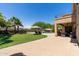Landscaped backyard view with an in-ground pool, patio, umbrellas, and lounge chairs at 18432 W Port Royale Ln, Surprise, AZ 85388