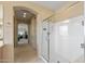 Bright bathroom featuring a glass enclosed shower, and doorway to an adjacent room at 18432 W Port Royale Ln, Surprise, AZ 85388