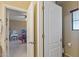 Bathroom doorway with view to a bedroom full of toys and dolls at 18432 W Port Royale Ln, Surprise, AZ 85388