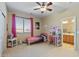 bedroom with twin bed, desk, and plenty of natural light at 18432 W Port Royale Ln, Surprise, AZ 85388