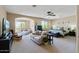 Spacious main bedroom retreat offers comfortable seating, bright light, and plush decor, creating a relaxing escape at 18432 W Port Royale Ln, Surprise, AZ 85388