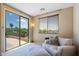 Serene bedroom with a relaxing view of greenery, comfortable seating, and great light at 18432 W Port Royale Ln, Surprise, AZ 85388