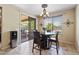 Breakfast nook with sliding glass doors to the backyard, chandelier, and tan tile flooring at 18432 W Port Royale Ln, Surprise, AZ 85388