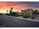 Exterior view of a two-story home with a three-car garage and desert landscaping at 18432 W Port Royale Ln, Surprise, AZ 85388