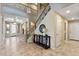 Welcoming foyer features a staircase, decor, and tile flooring for an inviting entrance at 18432 W Port Royale Ln, Surprise, AZ 85388