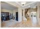 Open foyer with tile flooring, staircase, and an inviting view of the home's layout at 18432 W Port Royale Ln, Surprise, AZ 85388