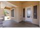 Inviting front porch with stone accents, offering a warm welcome at 18432 W Port Royale Ln, Surprise, AZ 85388
